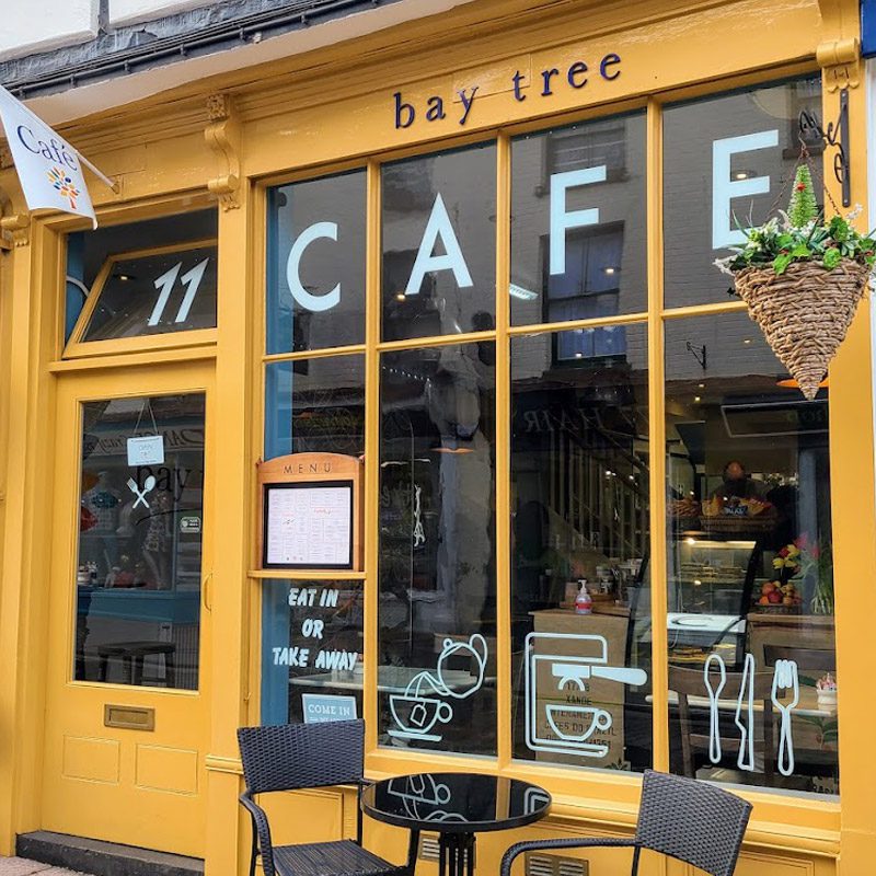 Vibrant yellow exterior of The Bay Tree Cafe